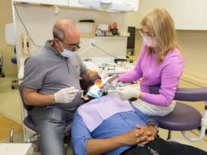 Dr. Slepchik and an assistant working on a patient