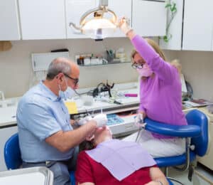 Dr. Slepchik and a dental assistant working on a patient with a root canal