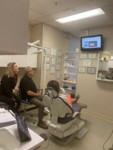 Dr. Lenny Slepchik discusses Invisalign treatment with a patient in downtown Montreal